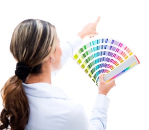 Woman decorating the house and choosing a color for the wall